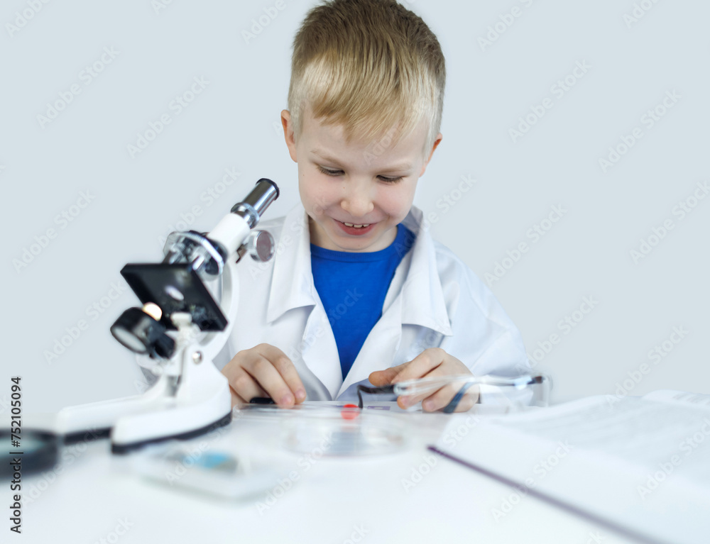 Child chemist. Teacher shows a visual experiment. A science mentor teaches an experimental approach. Microscope, petri dish, pipettes, books. Practical work in chemistry or physics. Laboratory work Child chemist. Teacher shows a visual experiment. A science mentor teaches an experimental approach. Microscope, petri dish, pipettes, books. Practical work in chemistry or physics. Laboratory work