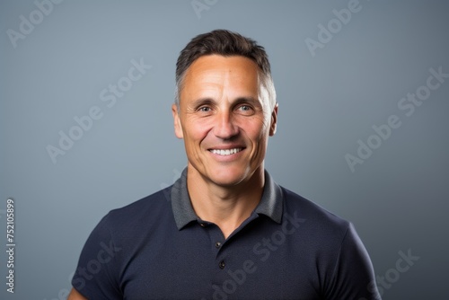 Handsome middle age man with a funny expression over grey background
