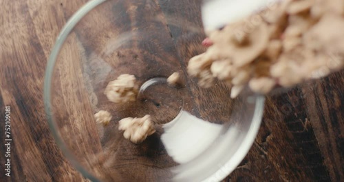 Muesli cereal granola oats poured in cup breakfast top down close up