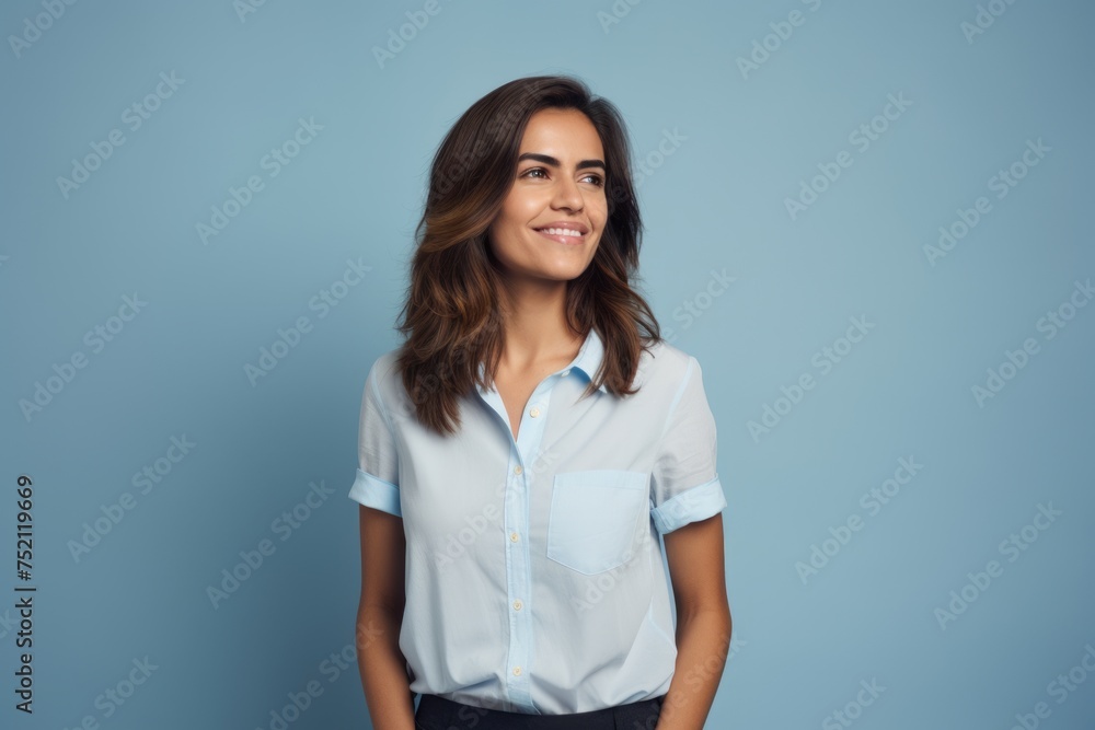 Portrait of smiling businesswoman in white shirt on blue background. Portrait of smiling businesswoman in white shirt on blue background.