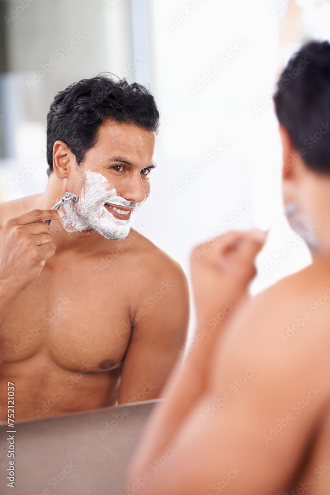 Hair removal, man and shaving foam on face in bathroom mirror for grooming, morning routine and razor. Smile, skincare and male person for wellness, facial treatment or cosmetics with reflection.