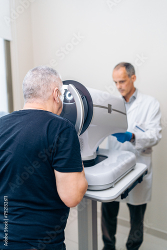 A man consults with a doctor at an eye treatment facility.