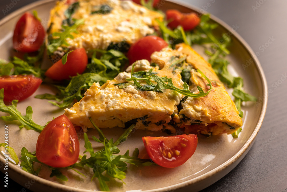 delicious spring frittata for a perfect brunch with arugula and cherry tomatoes close-up delicious spring frittata for a perfect brunch with arugula and cherry tomatoes close-up