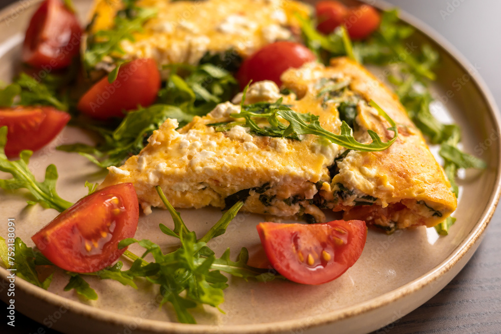 delicious spring frittata for a perfect brunch with arugula and cherry tomatoes close-up delicious spring frittata for a perfect brunch with arugula and cherry tomatoes close-up