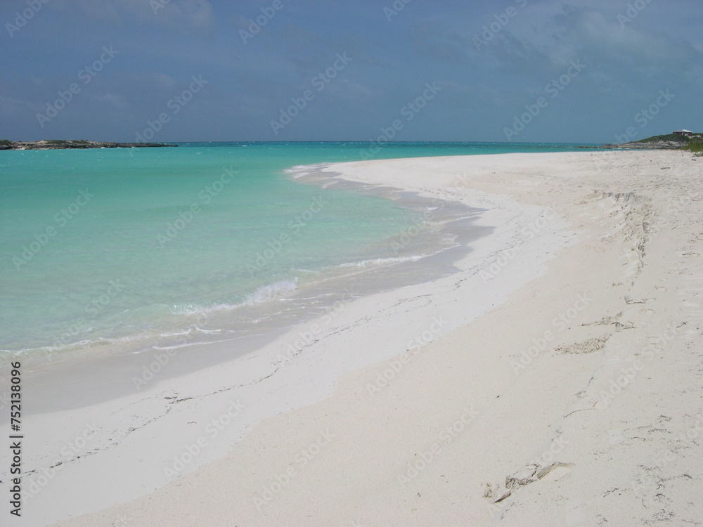 Turquoise sea water and blue sky in Tropic of Cancer Beach, Little Exuma Island, Bahamas.