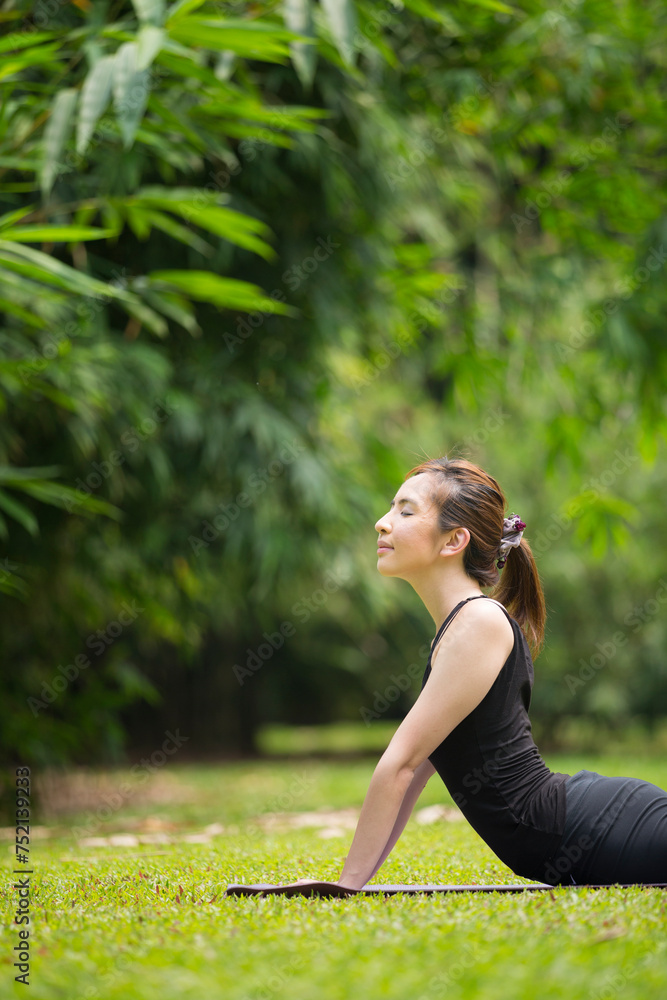 Chinese woman practicing yoga outdoors. Chinese woman practicing yoga outdoors.