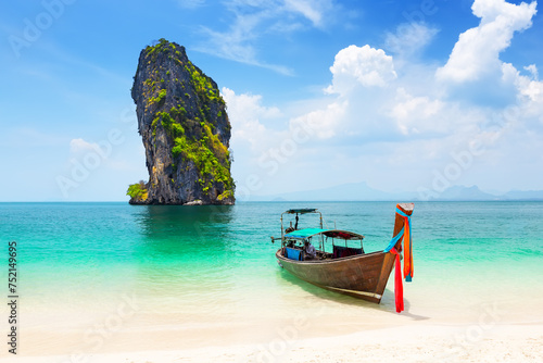 Thai traditional wooden longtail boat and beautiful sand beach at Koh Poda island in Krabi province, Thailand.