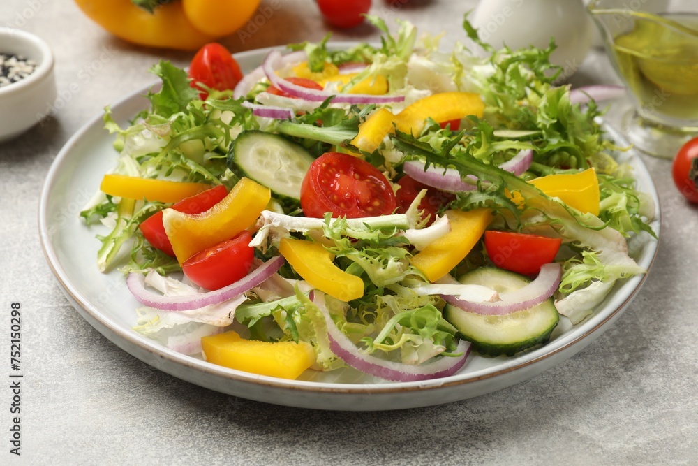 Tasty fresh vegetarian salad on grey table, closeup Tasty fresh vegetarian salad on grey table, closeup