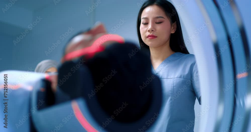 Friendly doctor finishing magnetic resonance tomography. Close up of ...