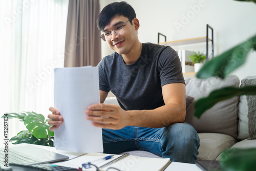The happy man satisfied when he gets good news in paper, finishes work, makes a good business deal, job promotion, loan approval, great exam result photo