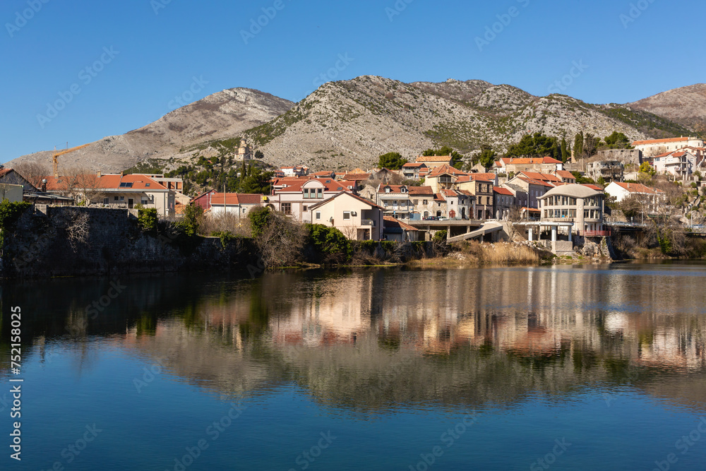 Trebinje city. Balkan houses in city center with red roofs and mountains at background, Balkan vibe. Old city Trebinje, Bosnia and Herzegovina