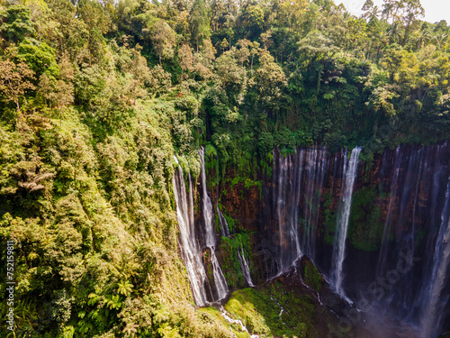 Aerial view of Tumpak Sewu waterfall. One of the biggest waterfalls in Indonesia with many streams of water falling down. A famous tourist destination in Lumajang Regency  East Java.