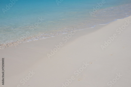 Soft blue ocean wave or clear sea on clean sandy beach 