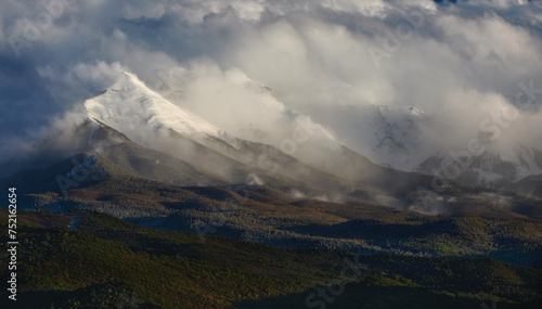 a snowy mountain that is in the middle of the day