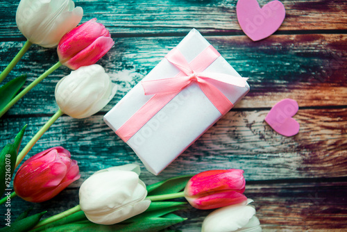 Fototapeta Naklejka Na Ścianę i Meble -  bouquet of pink and white tulips and gift box on wooden background. Easter or Mother's Day greeting card. Copy space for the text