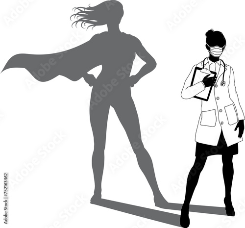 A superhero medical doctor woman health care worker revealed by her shadow silhouette as a super hero in a cape.