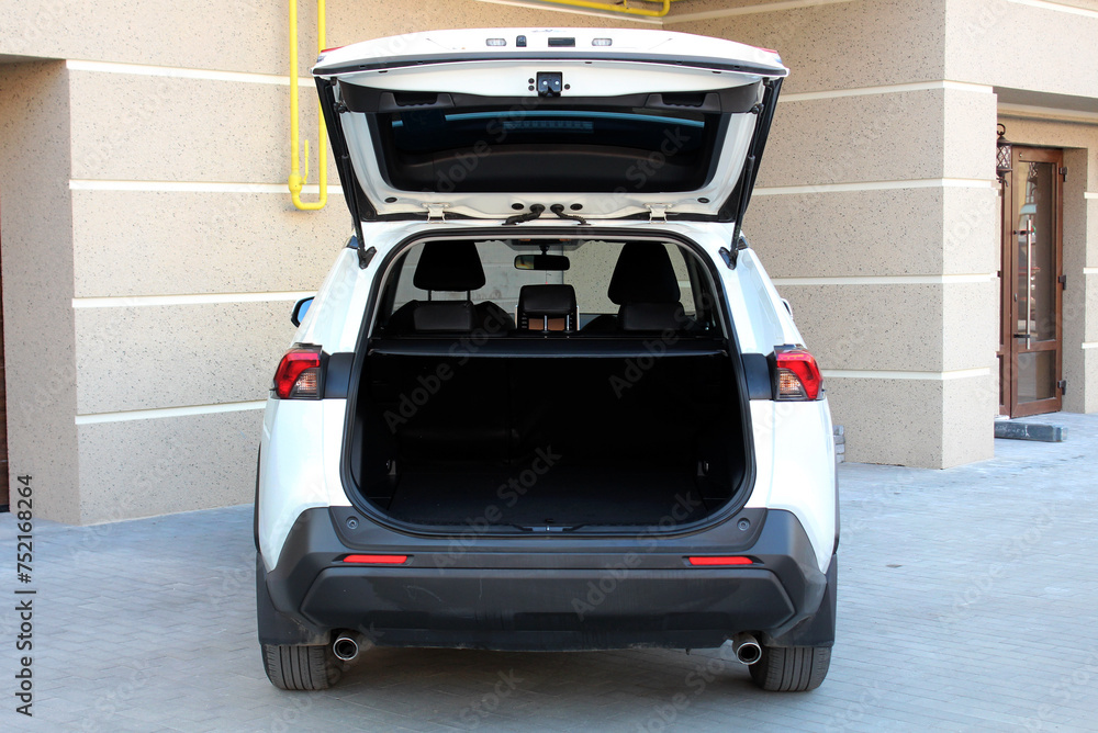 New white SUV open trunk. Modern car SUV with open empty trunk. Modern wagon car open trunk. Car boot is open.