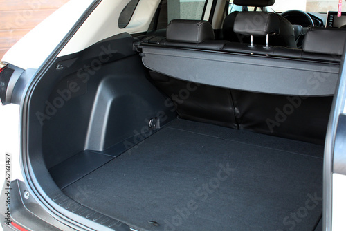 Premium SUV open trunk. Open empty trunk in the modern SUV. Car boot space shot. Modern SUV open trunk. Ready for luggage loading. Left view.
