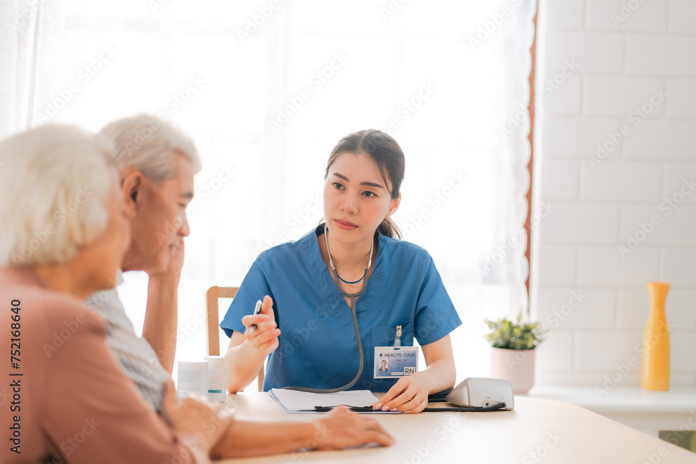 Health insurance service, Young Asian caregiver nurse examine senior man or woman patient at home. Attractive specialist career female support give advise and therapy consult to older elderly mature Health insurance service, Young Asian caregiver nurse examine senior man or woman patient at home. Attractive specialist career female support give advise and therapy consult to older elderly mature
