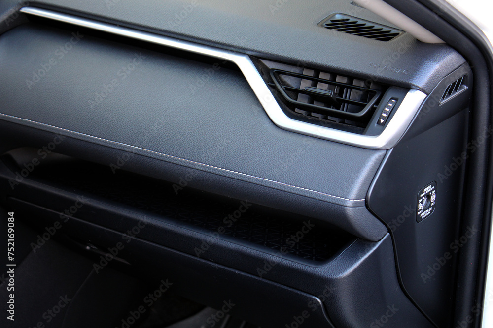 Car air vents close-up grille. Air ventilation grille with power regulator. Modern Car air conditioner, interior of a new modern car. Passenger airbag. Front airbag.