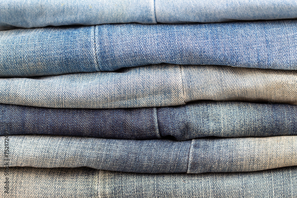 stack of blue jeans with different color characters, blue denim stack of blue jeans with different color characters, blue denim