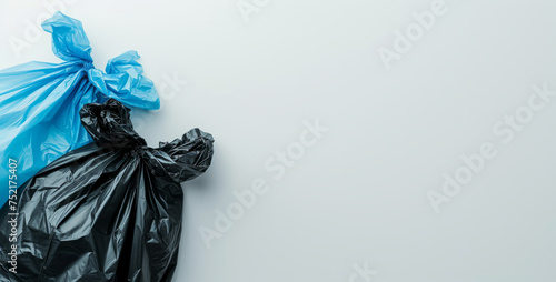 Multi-colored full garbage plastic bags on white background with copy space. Concept of environmentally friendly redistribution of waste