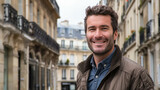 Happy And Smiling Man With A Backdrop Of Haussmannian Architecture And Building. Man In The Streets Of Paris Capital of France 