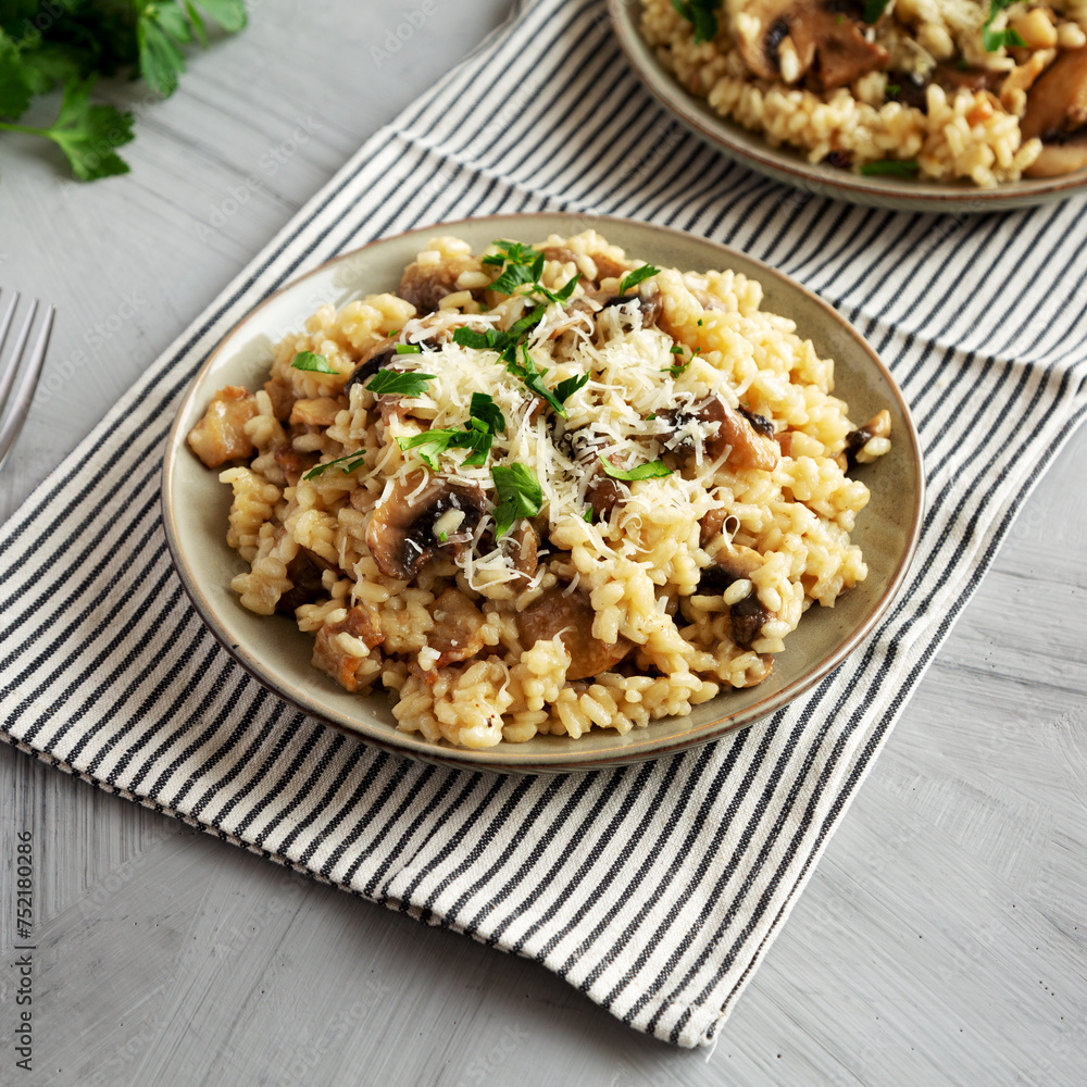 Homemade One-Pot Bacon And Mushroom Risotto on a Plate, side view. Homemade One-Pot Bacon And Mushroom Risotto on a Plate, side view.