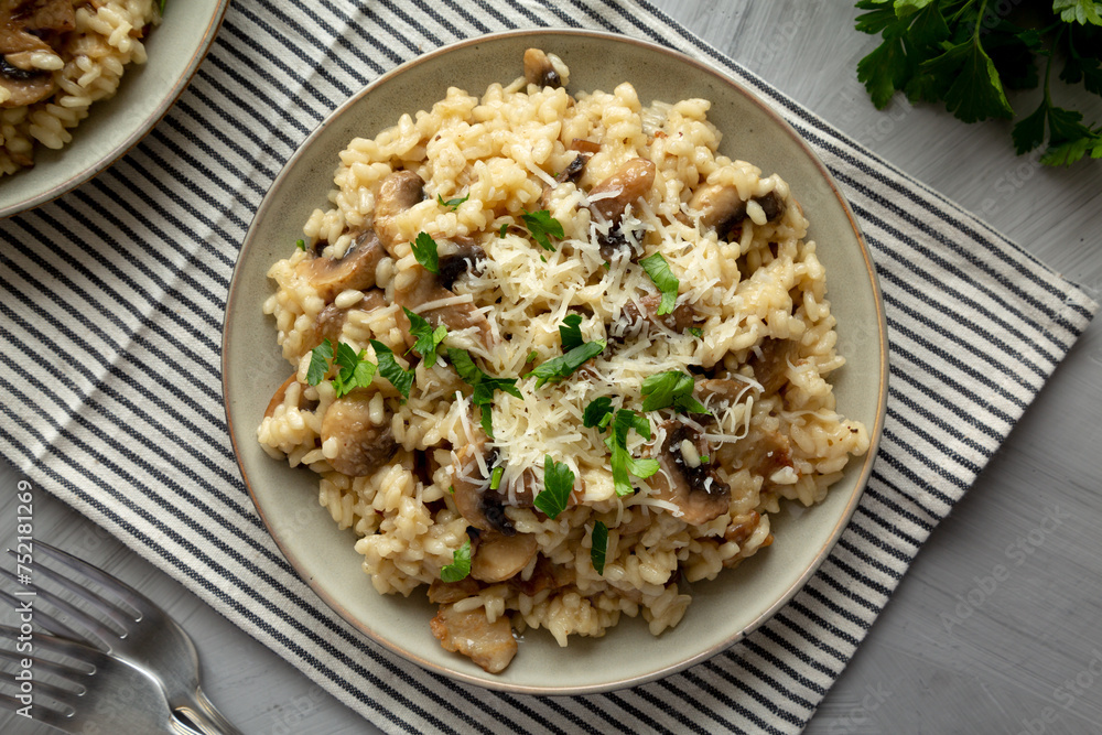 Homemade One-Pot Bacon And Mushroom Risotto on a Plate, overhead view. Flat lay, top view. Homemade One-Pot Bacon And Mushroom Risotto on a Plate, overhead view. Flat lay, top view.