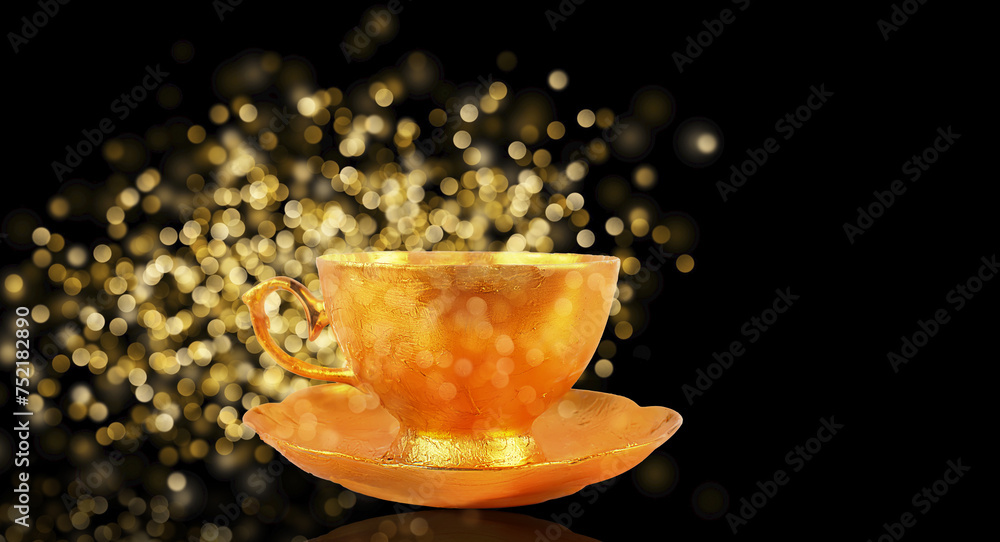 A golden cup and saucer with golden spots of bokeh spilling out on a black background. A golden cup and saucer with golden spots of bokeh spilling out on a black background.