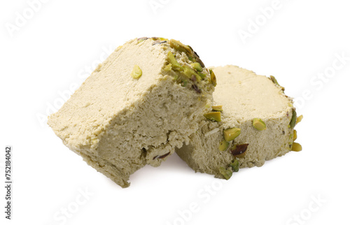 Pieces of tasty halva with pistachios on white background