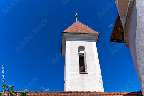 Looking up facade of catholic Church of St. Sebastian, Fabian and Roch at Pungart at the old town of Kranj on a sunny summer day. Photo taken August 10th, 2023, Kranj, Slovenia. photo