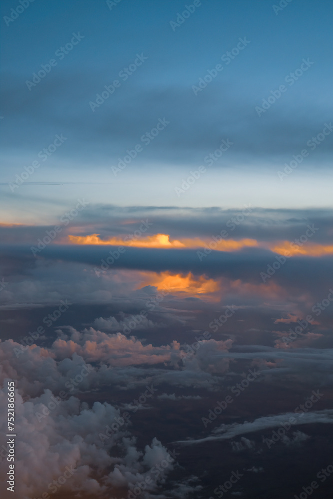 Dramatic sunset with clouds seen from an airplane