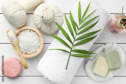 Flat lay composition with different spa products on white wooden table