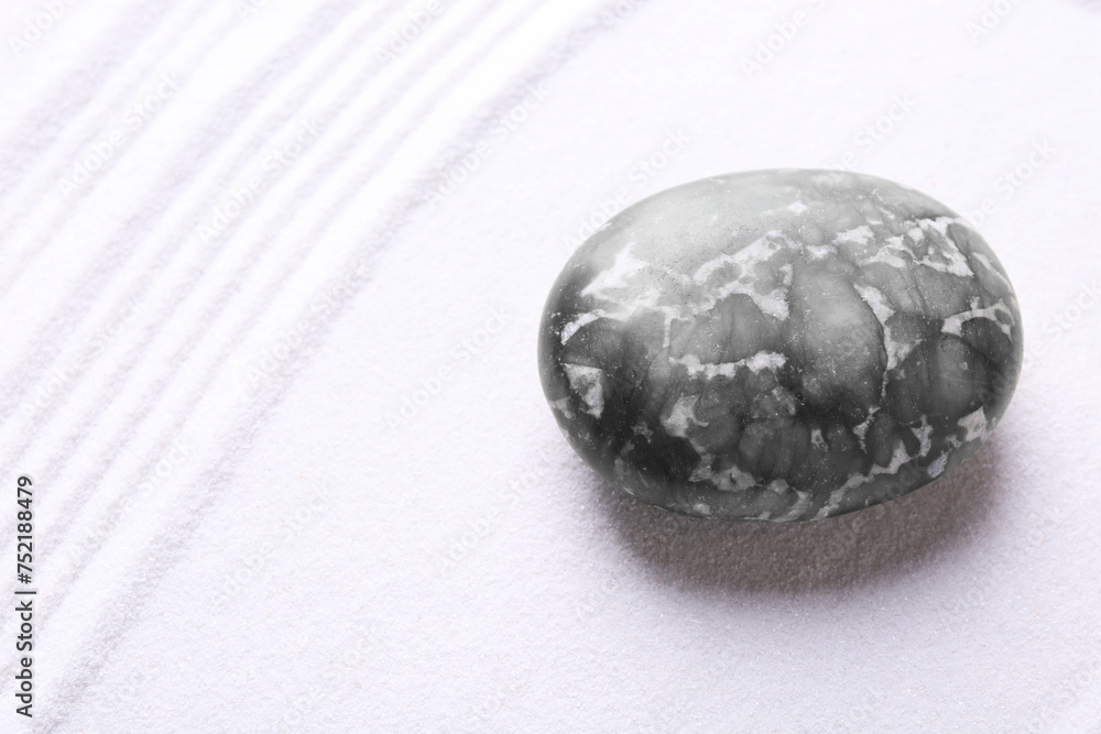 Stone on sand with pattern. Zen concept Stone on sand with pattern. Zen concept