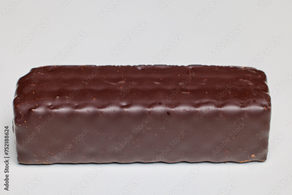 A wafer covered in chocolate on a white background A wafer covered in chocolate on a white background