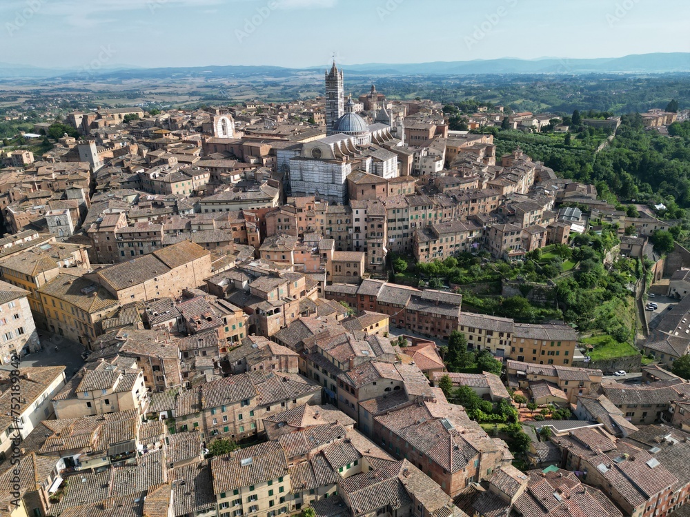 Aerial view of city with historic buildings and lush trees in Perugia, Italy