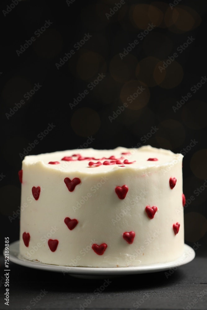 Bento cake with red cream hearts on black table, closeup. St. Valentine's day surprise Bento cake with red cream hearts on black table, closeup. St. Valentine's day surprise