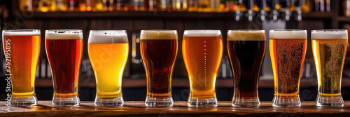 An array of craft beer glasses showcasing a spectrum of ales and lagers on a well-lit bar top.