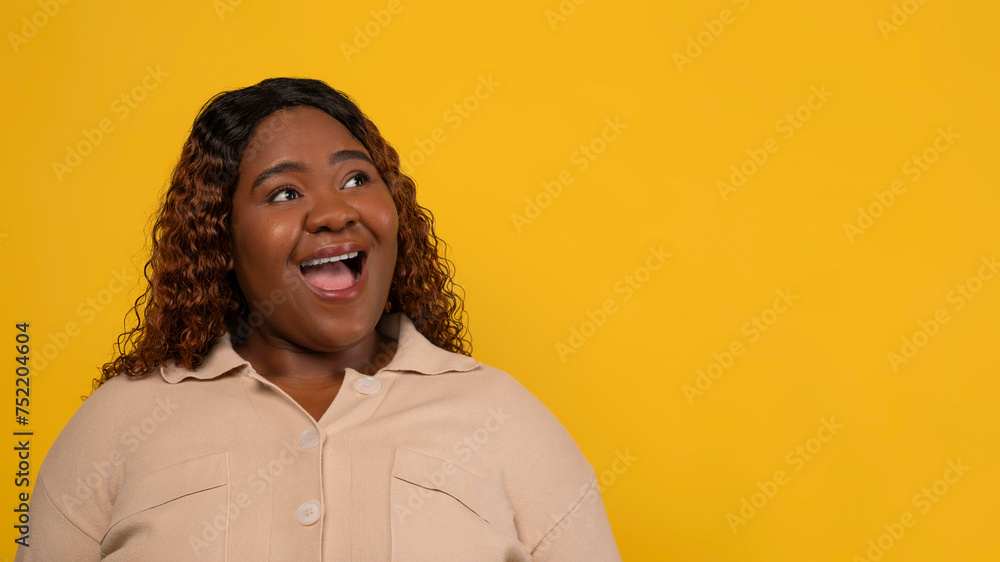 Curious chubby black woman looking at copy space Curious chubby black woman looking at copy space