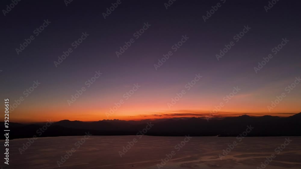 Drone glides over Palawan at sunset, showcasing sea, sky, and silhouettes of Puerto Princesa's mountains at 7 PM. Drone glides over Palawan at sunset, showcasing sea, sky, and silhouettes of Puerto Princesa's mountains at 7 PM.