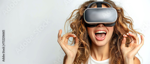Young woman in virtual reality using a virtual reality glasses headset, standing on a light background. Modern technologies, virtual reality.