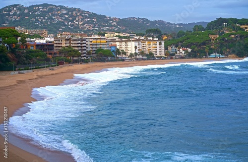 Fenals Beach, Lloret de Mar Spain. Top view of a deserted beach in cloudy weather, blue, turquoise, thick water, green vegetation, storm at sea. Mediterranean, transparent, nature, tourism photo