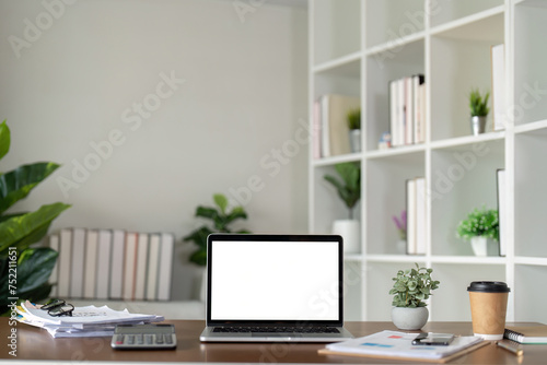 Mock up blank white screen laptop, book and home decor. Sustainability eco friendly lifestyle © Natee Meepian