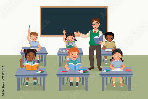Young male teacher teaching students in the classroom
