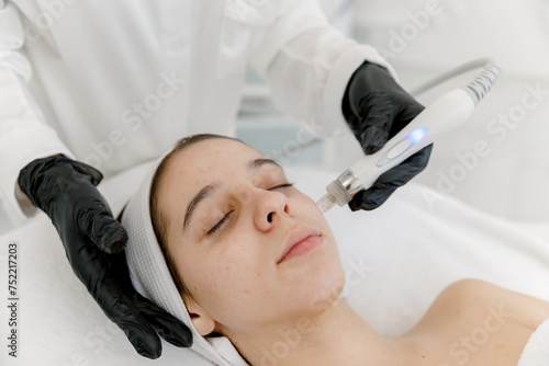 Vacuum facial cleansing woman's face. Teen skin. Hydra peeling. 