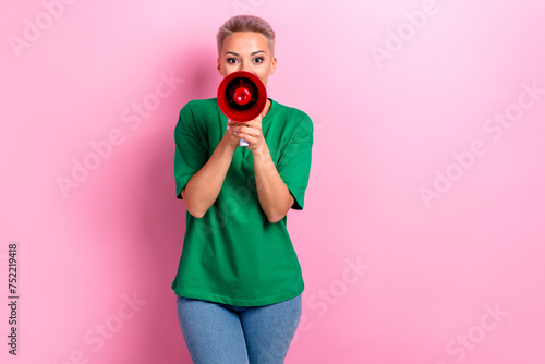 Photo of adorable lovely woman marketer wear green stylish clothes proclaim special offer isolated on pink color background photo