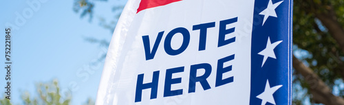 Panorama Vote Here high resolution text on political vote flag banner fiberglass poles, polyester double-sided election decorations polling locations on rotating pole, non-English-proficient, TX. USA