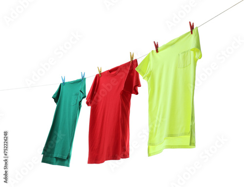 Colorful t-shirts drying on washing line isolated on white