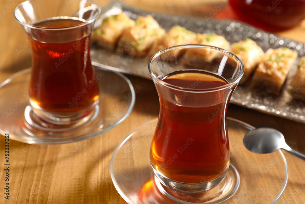 Traditional Turkish tea in glasses on wooden table, closeup Traditional Turkish tea in glasses on wooden table, closeup